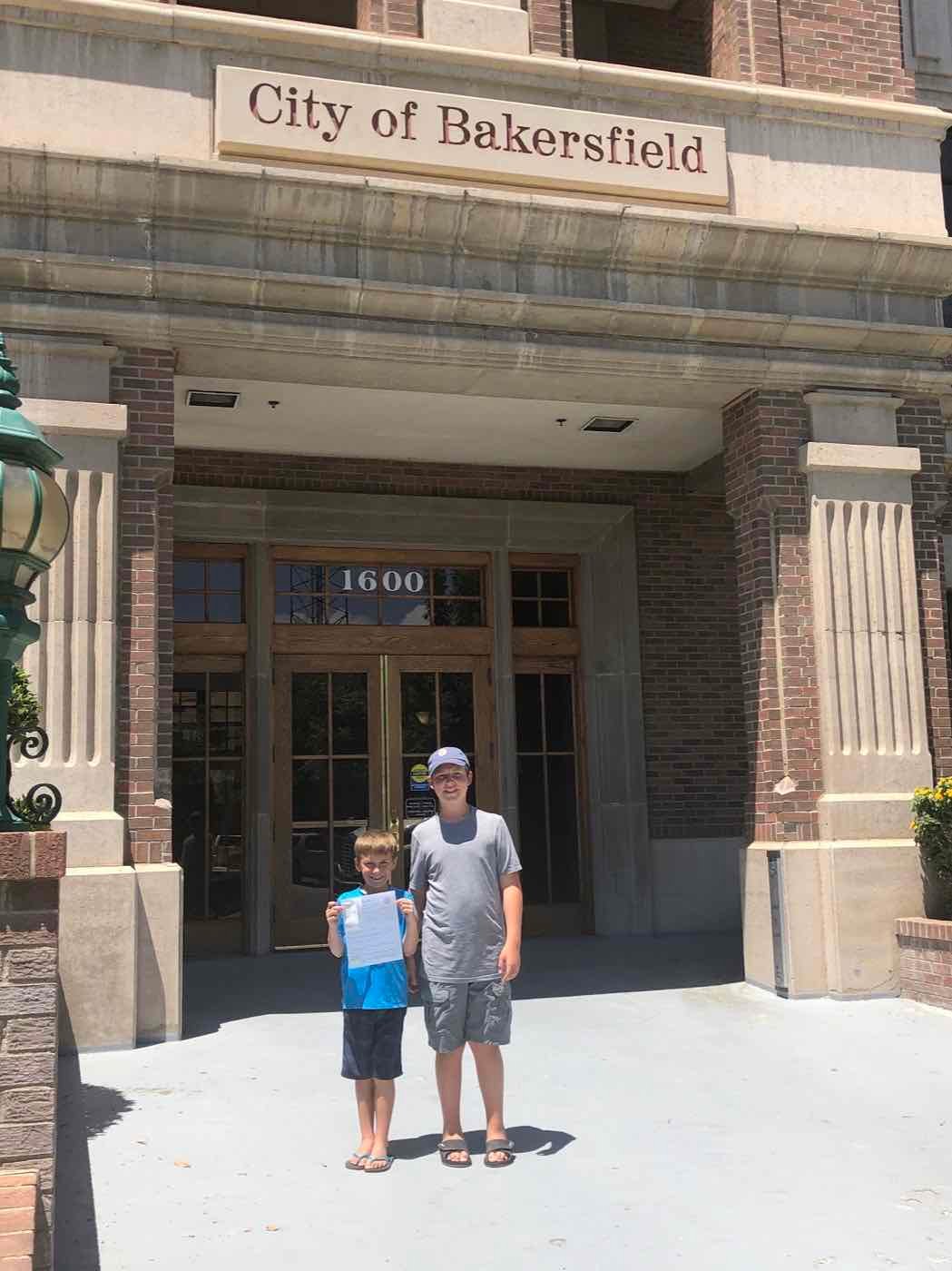 Blake and Zachary outside Bakersfield City Hall holding their new business license