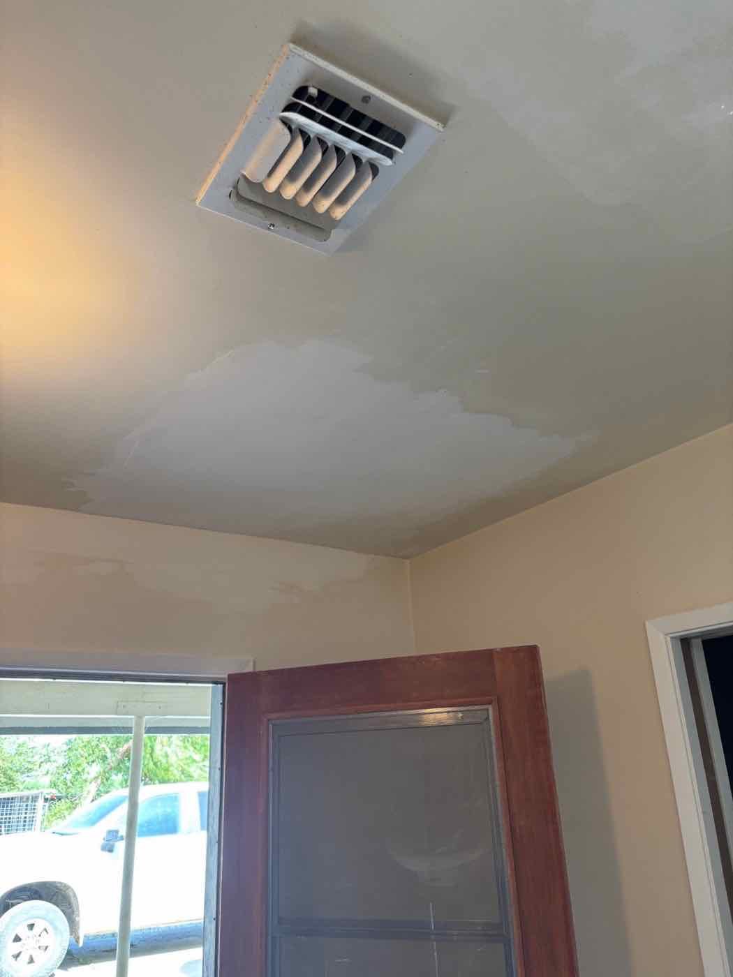 The ceiling after the drywall was replaced and patched smooth